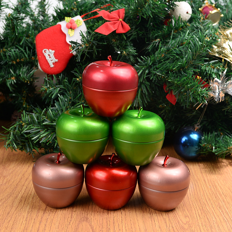 Christmas scented candle in an apple-shaped tin